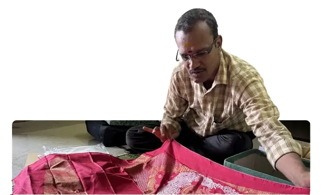 man showing beautiful piece of sari